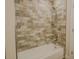Bathroom shower featuring a tub and beautifully tiled walls at 35150 Roth Ln, Dade City, FL 33525
