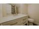 Bathroom featuring a white vanity with marble countertop, chrome fixtures, and a toilet at 35150 Roth Ln, Dade City, FL 33525