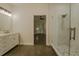 Bathroom featuring a glass shower, tiled flooring, and vanity with cabinet and drawer storage at 35150 Roth Ln, Dade City, FL 33525