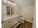Bathroom featuring a white vanity with marble countertop, chrome fixtures, and wood-look tile flooring at 35150 Roth Ln, Dade City, FL 33525