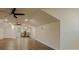 Large bonus room featuring high ceilings, wood flooring, and multiple ceiling fans at 35150 Roth Ln, Dade City, FL 33525