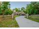 Charming single-story home with stone accents, a two-car garage, and a wooden fence at 35150 Roth Ln, Dade City, FL 33525
