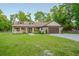 Charming single-story home with manicured lawn, stone accents, and attached garage at 35150 Roth Ln, Dade City, FL 33525