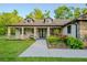 Charming home with dormer windows, black framed windows and landscaped front yard at 35150 Roth Ln, Dade City, FL 33525