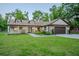 Charming home with manicured front yard, stone accents, attached garage, and inviting entryway at 35150 Roth Ln, Dade City, FL 33525
