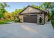 Exterior of stone and siding garage with a large concrete driveway at 35150 Roth Ln, Dade City, FL 33525