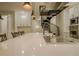 Large kitchen island features seating and a cooktop next to the spiral staircase at 35150 Roth Ln, Dade City, FL 33525