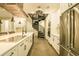 A chef's kitchen with white cabinetry, stainless appliances, concrete flooring, and spiral staircase at 35150 Roth Ln, Dade City, FL 33525