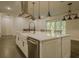 Bright kitchen showcases a large island, stainless steel appliances, and pendant lighting at 35150 Roth Ln, Dade City, FL 33525