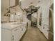 Spacious kitchen features a spiral staircase, white cabinets, and stainless steel appliances at 35150 Roth Ln, Dade City, FL 33525