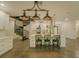 Bright modern kitchen with white cabinets, island seating, stainless appliances, and an adjacent spiral staircase at 35150 Roth Ln, Dade City, FL 33525