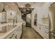 Modern kitchen featuring an island cooktop, stainless steel appliances, white cabinetry, and a spiral staircase accent at 35150 Roth Ln, Dade City, FL 33525