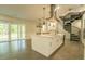 Bright, modern kitchen features a large island, stainless steel appliances, and a unique spiral staircase at 35150 Roth Ln, Dade City, FL 33525