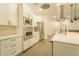 Modern kitchen boasts white cabinets, stainless steel appliances, and sleek countertops at 35150 Roth Ln, Dade City, FL 33525