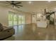 Open concept living room leads into the modern kitchen and spiral staircase at 35150 Roth Ln, Dade City, FL 33525