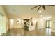 Open concept living space with modern kitchen, spiral staircase, concrete floors and large windows, filling the space with light at 35150 Roth Ln, Dade City, FL 33525