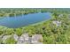 Scenic aerial view of community homes nestled near a serene lake surrounded by lush greenery at 3621 Country Pointe Pl, Palm Harbor, FL 34684