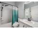 Bathroom featuring a single sink, vanity, large mirror, and a shower-tub combo with a curtain at 3621 Country Pointe Pl, Palm Harbor, FL 34684
