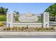 Elegant entrance sign reading Lake Pointe at Countryside with manicured flowerbeds at 3621 Country Pointe Pl, Palm Harbor, FL 34684
