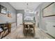 Bright dining room with modern lighting and wood-look floors at 3621 Country Pointe Pl, Palm Harbor, FL 34684