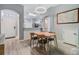 Bright dining room with modern lighting and wood-look floors at 3621 Country Pointe Pl, Palm Harbor, FL 34684