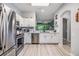 Modern kitchen featuring stainless steel appliances, sleek white cabinets, and ample counter space at 3621 Country Pointe Pl, Palm Harbor, FL 34684