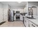 Bright kitchen featuring stainless steel appliances and white cabinets at 3621 Country Pointe Pl, Palm Harbor, FL 34684