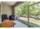 View of a screened-in lanai, featuring an outdoor table, and an air conditioning unit at 3621 Country Pointe Pl, Palm Harbor, FL 34684