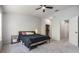 Main bedroom features a window, plush carpet, a ceiling fan, and a walk-in closet at 3621 Country Pointe Pl, Palm Harbor, FL 34684