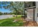 Backyard with waterfront views, shade trees, and a private patio entrance at 3821 N Oak Dr # J31, Tampa, FL 33611