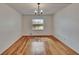 Bedroom with hardwood floors, neutral walls, and a bright window view at 3821 N Oak Dr # J31, Tampa, FL 33611