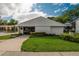 Manicured lawn enhances the exterior of the clubhouse with beautiful green landscaping and a concrete sidewalk at 3821 N Oak Dr # J31, Tampa, FL 33611