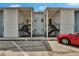 Multi-Gathering condo with well-maintained facade, black railings, and a glimpse of a parked red car at 3821 N Oak Dr # J31, Tampa, FL 33611