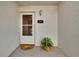 Inviting entryway featuring a charming welcome mat and a decorative house number for a personal touch at 3821 N Oak Dr # J31, Tampa, FL 33611