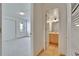 Hallway with views into a bedroom and bathroom with tiled floors and a sink vanity at 3821 N Oak Dr # J31, Tampa, FL 33611
