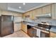 Functional kitchen featuring ample cabinetry, stainless steel appliances, and tile flooring for a modern touch at 3821 N Oak Dr # J31, Tampa, FL 33611