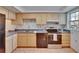 Well-equipped kitchen featuring classic cabinets, stainless appliances, tile backsplash, and ample counter space at 3821 N Oak Dr # J31, Tampa, FL 33611