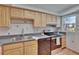 Functional kitchen with light wood cabinets, stainless steel appliances, and a view from the window at 3821 N Oak Dr # J31, Tampa, FL 33611