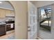 View of a kitchen with a stainless steel stove and tile backsplash from doorway at 3821 N Oak Dr # J31, Tampa, FL 33611