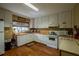Functional kitchen with white cabinets, laminate countertops, and essential appliances for convenient meal preparation at 3821 N Oak Dr # J31, Tampa, FL 33611