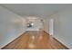 Expansive living room with hardwood flooring, showcasing seamless flow to kitchen and doorways at 3821 N Oak Dr # J31, Tampa, FL 33611
