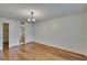 Inviting living room offers hardwood floors, decorative pendant lighting, and access to bathroom at 3821 N Oak Dr # J31, Tampa, FL 33611