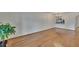 Open-concept living room with hardwood floors and a view of the adjacent kitchen area at 3821 N Oak Dr # J31, Tampa, FL 33611