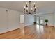 Bright living room featuring hardwood floors, elegant chandelier, and access to an outdoor space at 3821 N Oak Dr # J31, Tampa, FL 33611