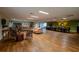 Large meeting room with wood flooring, multiple seating areas, and long conference table at 3821 N Oak Dr # J31, Tampa, FL 33611