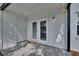 Outdoor patio area featuring double glass doors, a doormat, and exterior lighting at 3821 N Oak Dr # J31, Tampa, FL 33611