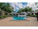 Community pool with multiple lounge chairs surrounded by well-maintained grounds and lush landscaping at 3821 N Oak Dr # J31, Tampa, FL 33611
