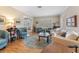 Cozy living room featuring hardwood floors, stylish furniture, a decorative rug, and window shutters at 4214 W Beach Park Dr, Tampa, FL 33609