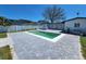 A beautiful backyard features a swimming pool, a gray-bricked patio, and a well-manicured lawn at 4619 Helena Ne St, St Petersburg, FL 33703