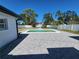 Beautiful backyard with a fenced-in pool, gray-bricked patio, and well-manicured lawn at 4619 Helena Ne St, St Petersburg, FL 33703
